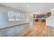 Open-concept living room with hardwood floors seamlessly flowing into a kitchen with an island at 6800 Franklin Heights Rd, Cary, NC 27518