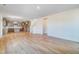 Spacious living room with hardwood floors leading to an open kitchen and dining area at 6800 Franklin Heights Rd, Cary, NC 27518
