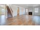 Inviting living room with a fireplace, staircase, and beautiful wood floors at 6800 Franklin Heights Rd, Cary, NC 27518