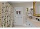 Bathroom showcasing a vanity, floral shower curtain, and decorative accents at 809 Wayne Dr, Raleigh, NC 27608