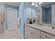 Bright bathroom with marble countertop, white cabinets, and a view of the shower adding luxury at 809 Wayne Dr, Raleigh, NC 27608