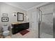 Bathroom showcasing a dark vanity, marble tile flooring, and glass enclosed walk-in shower at 809 Wayne Dr, Raleigh, NC 27608