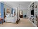 Serene bedroom with a four-poster bed, soft blue accents, and a custom built-in shelving unit at 809 Wayne Dr, Raleigh, NC 27608