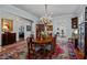 Formal dining room featuring an elegant chandelier, hardwood flooring, and a decorative rug at 809 Wayne Dr, Raleigh, NC 27608