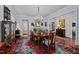 Open dining room featuring a large chandelier and colorful accent rug at 809 Wayne Dr, Raleigh, NC 27608