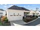 View of the house's side entrance with a two-car garage and charming exterior sconces at 809 Wayne Dr, Raleigh, NC 27608