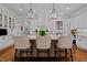 Kitchen features white cabinets, center island and bar seating at 809 Wayne Dr, Raleigh, NC 27608