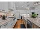 Kitchen featuring marble countertops, white cabinets, and a large island at 809 Wayne Dr, Raleigh, NC 27608