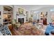 Bright living room featuring a fireplace, large windows, hardwood flooring, and stylish decor at 809 Wayne Dr, Raleigh, NC 27608
