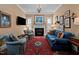 Cozy living room featuring a fireplace, blue seating, and a classic chandelier for a relaxed setting at 809 Wayne Dr, Raleigh, NC 27608