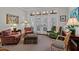 Bright living room featuring French doors, patterned seating, an ottoman, and stylish furnishings at 809 Wayne Dr, Raleigh, NC 27608