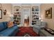 Elegant living room with built-in bookshelves and a view into the dining room, creating a seamless flow at 809 Wayne Dr, Raleigh, NC 27608
