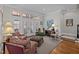 Inviting living room featuring French doors and seating with colorful, patterned upholstery and plush textures at 809 Wayne Dr, Raleigh, NC 27608