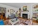 Comfortable living room with fireplace, built-in shelving, hardwood flooring, and designer furniture at 809 Wayne Dr, Raleigh, NC 27608