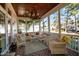 Charming screened-in porch with comfortable wicker furniture, a wooden ceiling, and a decorative chandelier at 809 Wayne Dr, Raleigh, NC 27608