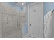 Modern walk-in shower featuring elegant tile work, glass door, and convenient grab bars for accessibility at 809 Wayne Dr, Raleigh, NC 27608