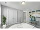 Comfortable bedroom featuring double doors, natural light, and a glass display table at 73 Merle Dr, Wendell, NC 27591