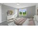 Sunlit bedroom with a large dresser, plush bed, and calming decor at 73 Merle Dr, Wendell, NC 27591