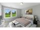 A luxurious bedroom showcasing a plush bed, stylish decor, and a beautiful outdoor view at 73 Merle Dr, Wendell, NC 27591