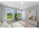 Serene bedroom with large windows offering scenic views, complemented by neutral decor at 73 Merle Dr, Wendell, NC 27591