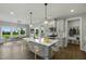 This open kitchen and dining area features an island with seating, stainless appliances and lots of natural light at 73 Merle Dr, Wendell, NC 27591