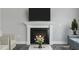 Cozy living room features a fireplace with a white mantle and a TV, complemented by neutral furniture and decor at 73 Merle Dr, Wendell, NC 27591