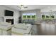 The open living room features a fireplace, comfortable seating, and large windows overlooking the expansive outdoor space at 73 Merle Dr, Wendell, NC 27591
