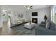 A bright living room features a fireplace, plush seating, and a minimalist design, with a neutral color palette at 73 Merle Dr, Wendell, NC 27591
