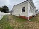 Fenced backyard showing access and partial brick foundation at 102 Sue Ave, Dunn, NC 28334