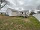 Fenced backyard with a small deck and room for outdoor activities at 102 Sue Ave, Dunn, NC 28334