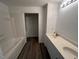 Well-lit bathroom features modern vanity and bathtub at 102 Sue Ave, Dunn, NC 28334