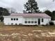 Charming single-story home featuring a metal roof, light-colored siding and a well-maintained lawn at 102 Sue Ave, Dunn, NC 28334