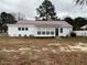 Charming single-story home featuring a metal roof, light-colored siding and a well-maintained lawn at 102 Sue Ave, Dunn, NC 28334
