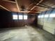 Interior view of an empty garage with exposed rafters at 102 Sue Ave, Dunn, NC 28334