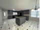 Updated eat-in kitchen featuring gray cabinets, granite countertops, an island and unique flooring at 102 Sue Ave, Dunn, NC 28334