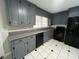 Updated kitchen featuring gray cabinets, granite countertops, and black appliances at 102 Sue Ave, Dunn, NC 28334