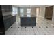 Updated eat-in kitchen featuring gray cabinets, granite countertops, an island and unique flooring at 102 Sue Ave, Dunn, NC 28334