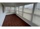 Sunroom with red tile floor and windows with blinds on all sides at 102 Sue Ave, Dunn, NC 28334
