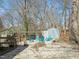 Backyard with fire pit, Adirondack chairs, shed, and covered dining space at 11424 Horsemans Trl, Raleigh, NC 27613