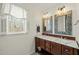 Bright bathroom featuring a double sink vanity, updated fixtures, and natural light at 11424 Horsemans Trl, Raleigh, NC 27613
