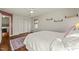 Bedroom featuring white walls and a comfortable bed with storage and stylish rug at 11424 Horsemans Trl, Raleigh, NC 27613