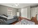 This spacious bedroom features gray walls, hardwood floors, and a white closet door at 11424 Horsemans Trl, Raleigh, NC 27613