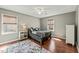 Bedroom with gray walls, hardwood floors, two windows with shades, and ceiling fan at 11424 Horsemans Trl, Raleigh, NC 27613