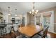 Dining room adjacent to updated kitchen with stainless steel appliances and bar seating at 11424 Horsemans Trl, Raleigh, NC 27613