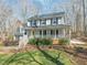Two-story home with a front porch, manicured lawn, and traditional architectural details at 11424 Horsemans Trl, Raleigh, NC 27613