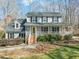 Charming two-story home with a welcoming front porch and professionally landscaped yard at 11424 Horsemans Trl, Raleigh, NC 27613