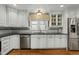 Modern kitchen with white cabinetry, stainless steel appliances, and hardwood floors at 11424 Horsemans Trl, Raleigh, NC 27613