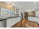 Open kitchen with white cabinetry, stainless steel appliances, and an adjacent dining area at 11424 Horsemans Trl, Raleigh, NC 27613