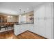 Bright kitchen with black countertops and white cabinets and adjacent dining area at 11424 Horsemans Trl, Raleigh, NC 27613