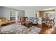 Open-concept living room with hardwood floors flows into dining area at 11424 Horsemans Trl, Raleigh, NC 27613